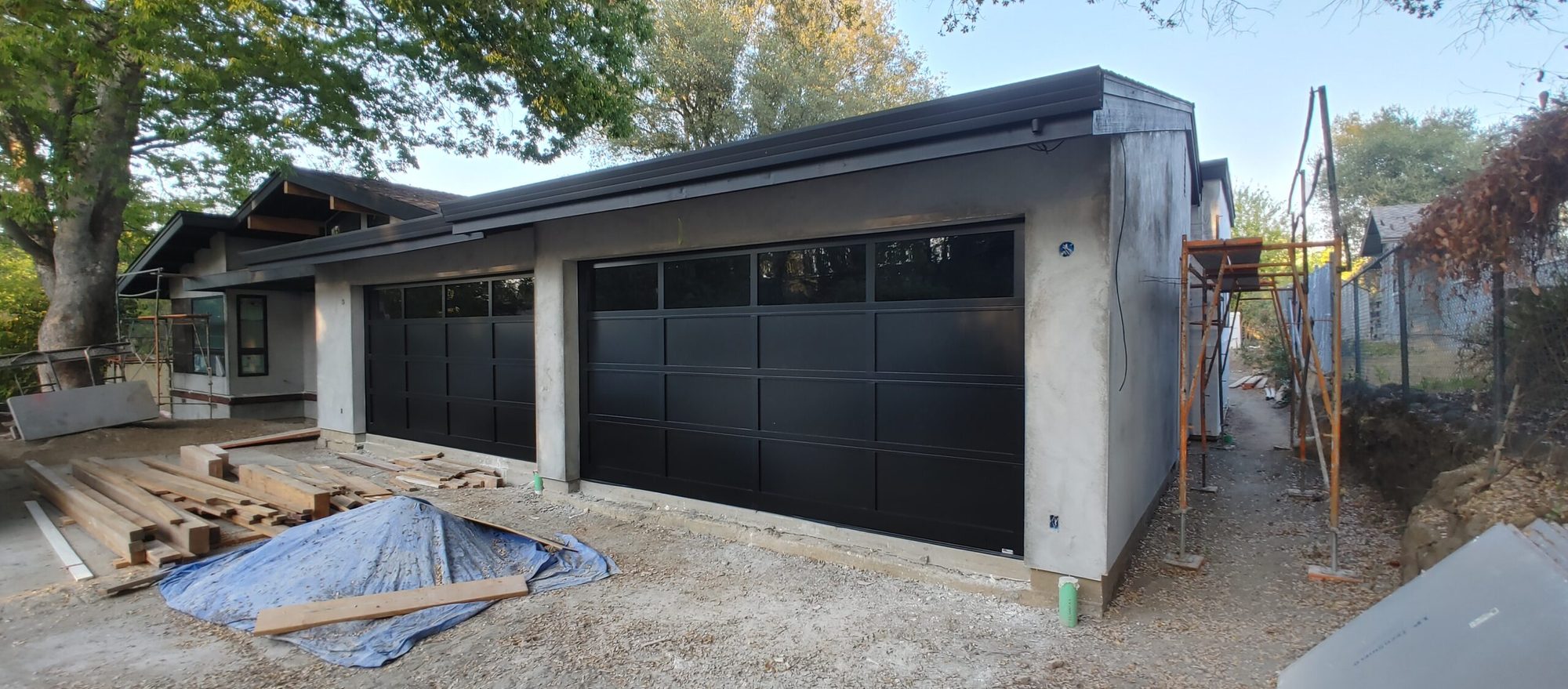 New black modern garage doors on a newly built home
